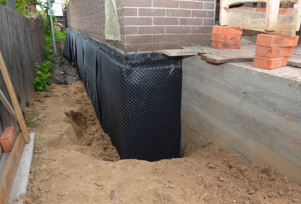 SJ Waterproofing Pros technician performing targeted Interior Drainage System assessment in Camden, TN
